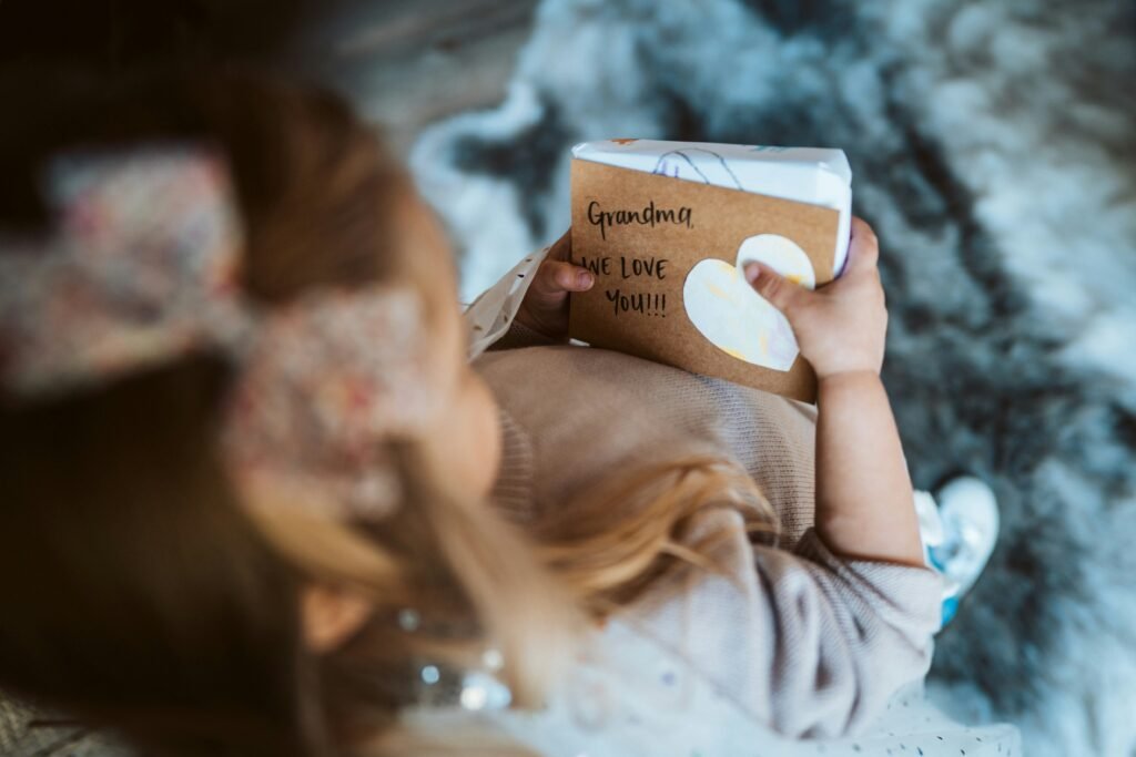 A young girl holding a legacy book created during end-of-life doula work