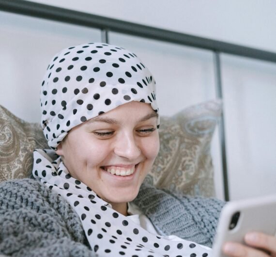 A supportive moment indoors featuring a cancer patient comforted by a friend