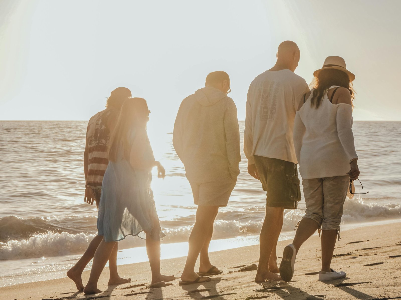 A group of walkers walking on the beach as part of the walking through grief program