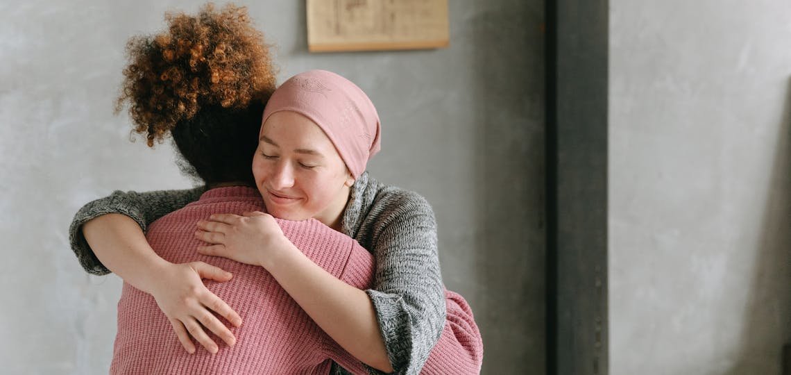 Two women embracing each other with anticipatory grief
