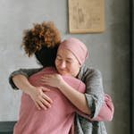 Two women embracing each other with anticipatory grief