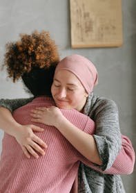 Two women embracing each other with anticipatory grief