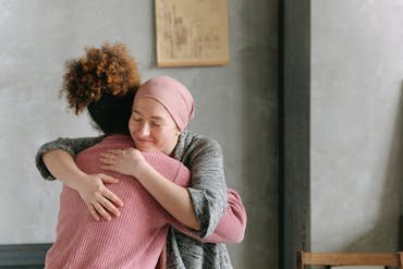 Two women embracing each other with anticipatory grief