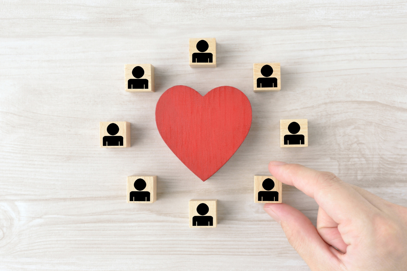 A heart with people figures around it, depicting Family Therapy at The Beach Haven