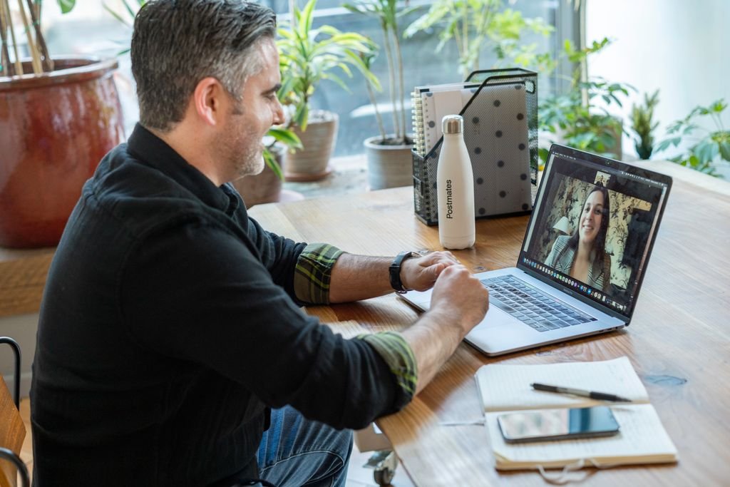 A man participates in an online discernment counselling session from his home.