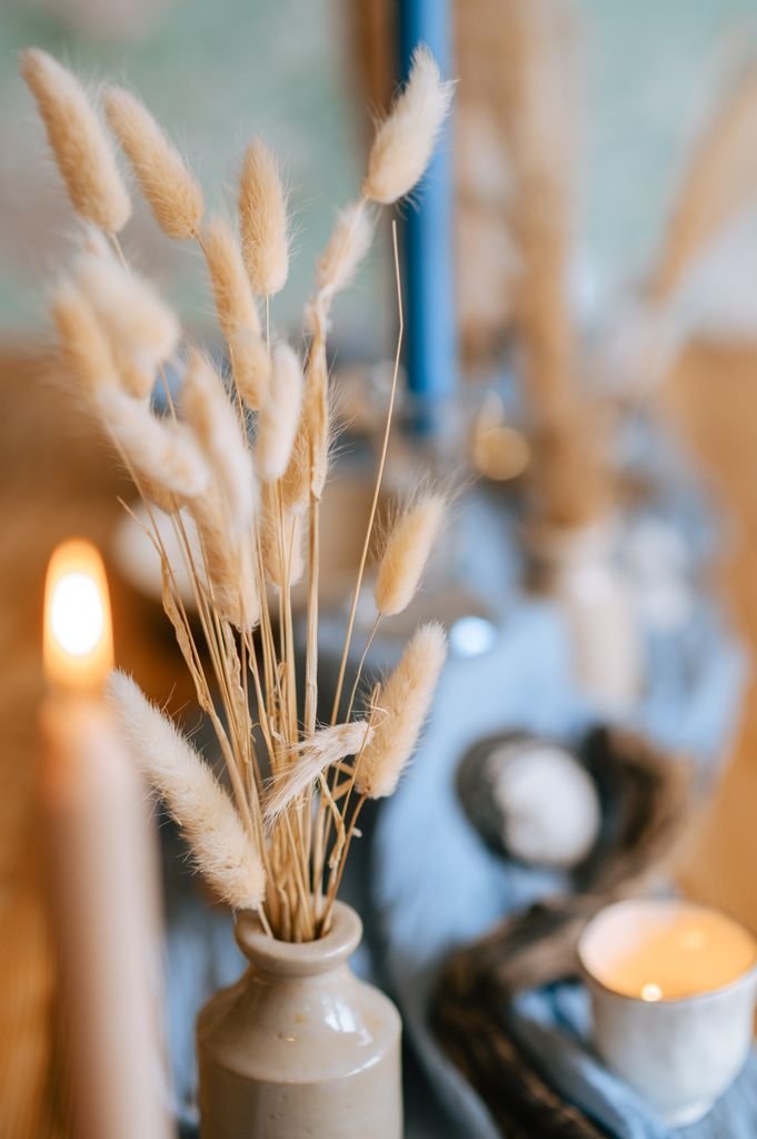 Elegant rustic table setting with seagrass and candles to create a safe haven for trauma and grief counselling at The Beach Haven